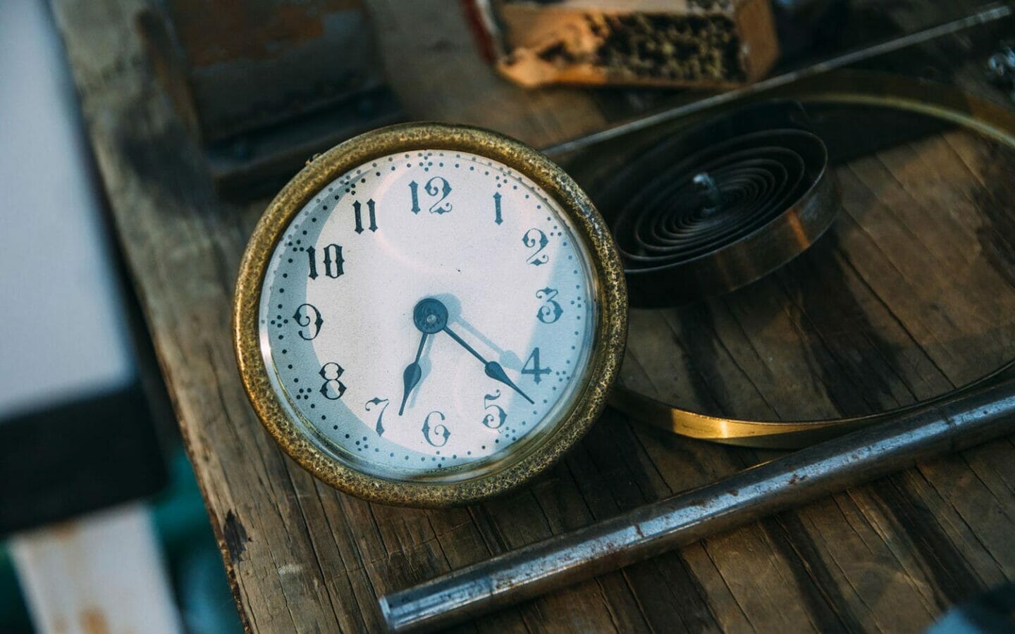 old watch sitting on wooden table