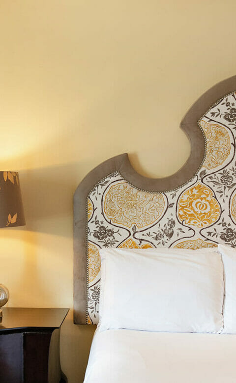 close up of hotel bed and nightstand