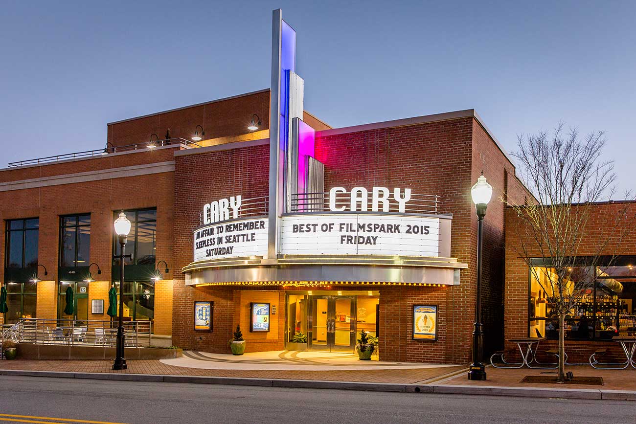 the exterior front marquee of a classic movie theatre at dusk