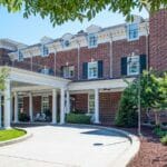 grand exterior of The Mayton Hotel, a beautiful old brick building in downtown Cary, NC