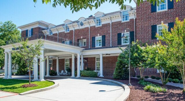 grand exterior of The Mayton Hotel, a beautiful old brick building in downtown Cary, NC