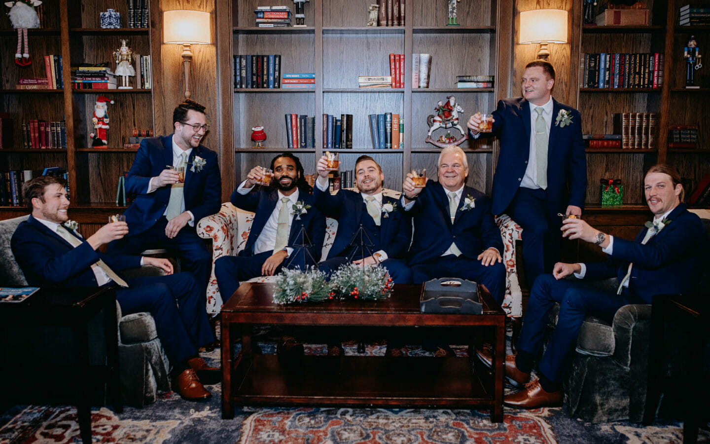 group of men in formal suits having a toast