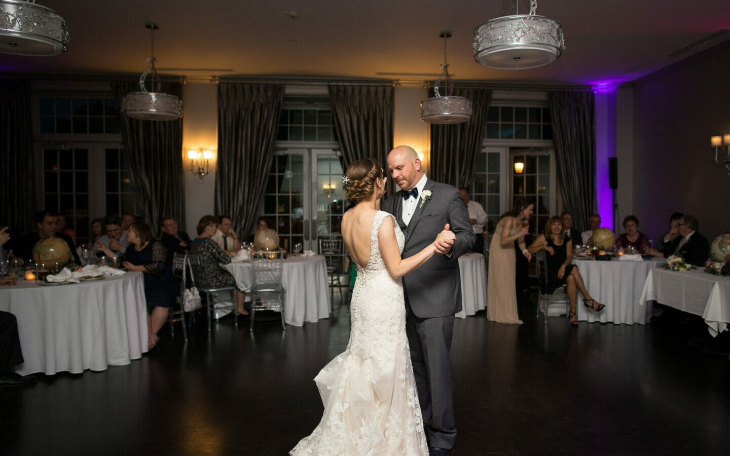 man in suit dancing with woman in bridal gown