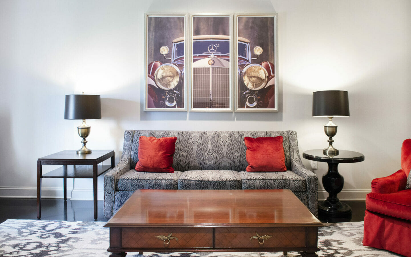 living space in hotel suite with couch, chaise, coffee table and large area rug