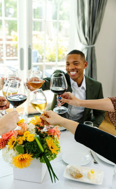 people toasting with a plated dinner in the Park Room