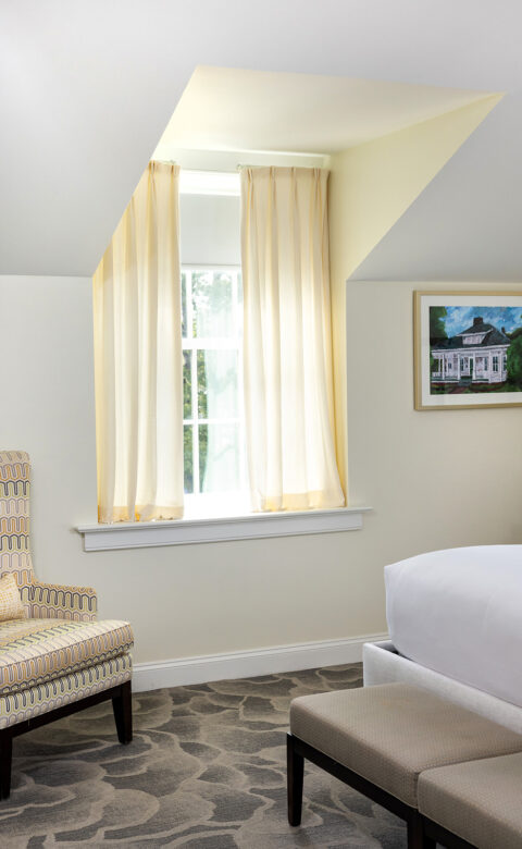 Room with sofa and bed with a small window