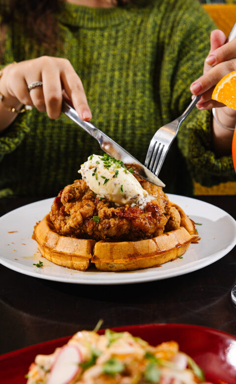a woman sitting at a table with a plate of food